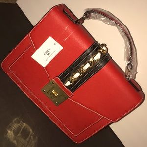 Red purse with blue and gold strap